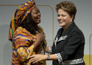 Brazil's President Dilma Rousseff, right, embraces Nnenna Nwakanma, a free Internet activist from Nigeria, at the opening ceremony of NETmundial, a major conference on the future of Internet governance in Sao Paulo, Brazil, Wednesday, April 23, 2014. Brazil has cast itself as a defender of Internet freedom following revelations last year that Rousseff was the object of surveillance by the United States' National Security Agency. (AP Photo/Andre Penner)