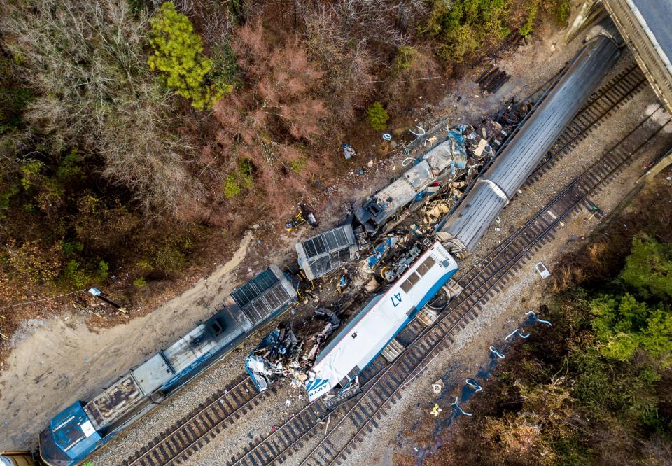 An aerial view of the site of a fatal train crash between an Amtrak train, bottom right, and a CSX freight train, top left, in Cayce, S.C.  The NTSB has previously said that a switch was left in the wrong position, sending a New York-to-Miami Amtrak passenger train onto a side track where a CSX freight train was parked after offloading materials nearby.