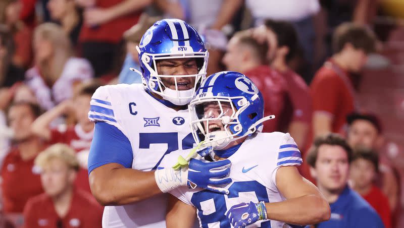 BYU wide receiver Parker Kingston (82) celebrates his touchdown with offensive lineman Kingsley Suamataia (78) at Razorback Stadium in Fayetteville on Saturday, Sept. 16, 2023.