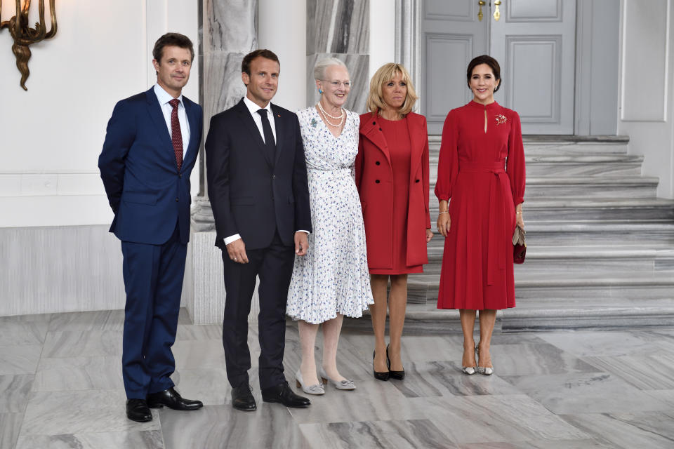 French President Emmanuel Macron, left and first lady Brigitte Macron, second arrive at Amalienborg Castle where they are officially welcomed by Denmark's Queen Margrethe, centre and Denmark's Crown Prince Frederik, left and Crown Princess Mary in Copenhagen Denmark, Tuesday Aug. 28, 2018. Macron is on a two-day visit, hoping to build the relationships he needs to push France’s agenda of a more closely united European Union. (Tariq Mikkel Khan/Ritzau Scanpix via AP)