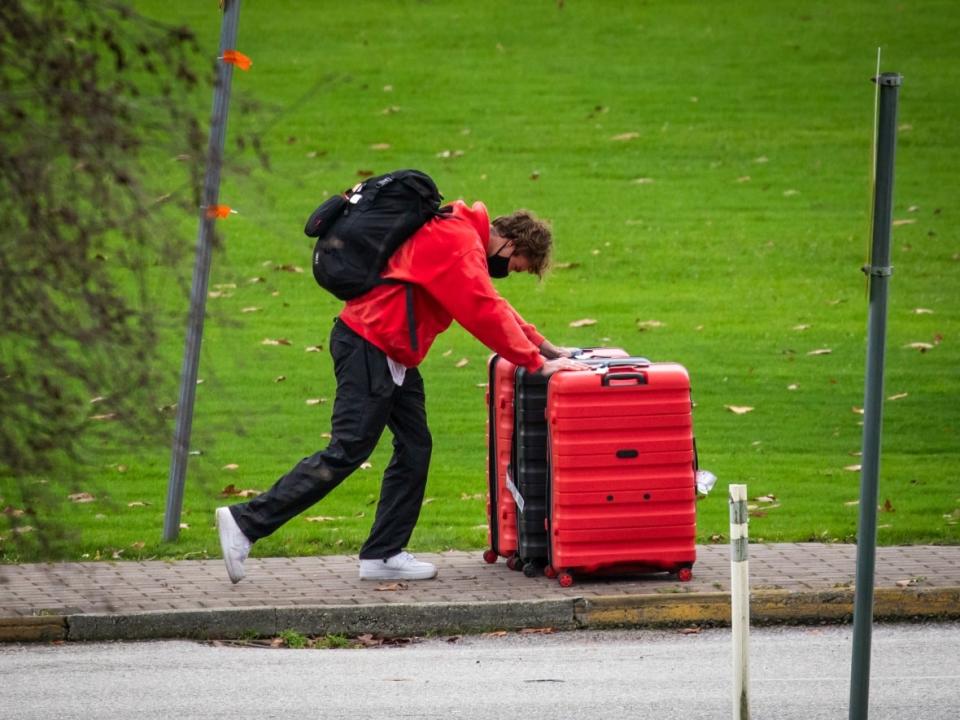 A traveller pushes their suitcases back into Canada at the Canada-U.S.A international border crossing in Surrey, British Columbia on Wednesday, December 1, 2021.  (Ben Nelms/CBC - image credit)