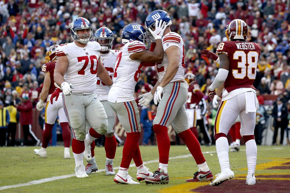 New York Giants wide receiver Sterling Shepard, center left, congratulates tight end Kaden Smith after he caught a touchdown pass from quarterback Daniel Jones during the second half of an NFL football game against the Washington Redskins, Sunday, Dec. 22, 2019, in Landover, Md. (AP Photo/Alex Brandon)