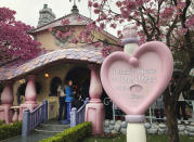 Visitors enter Minnie's House at Disneyland in Anaheim, Calif., Friday, March 13, 2020. Disneyland is closing its doors for the rest of the month, shuttering one of California's best-known attractions as the state hurries to stop the spread of the coronavirus. (AP Photo/Amy Taxin)