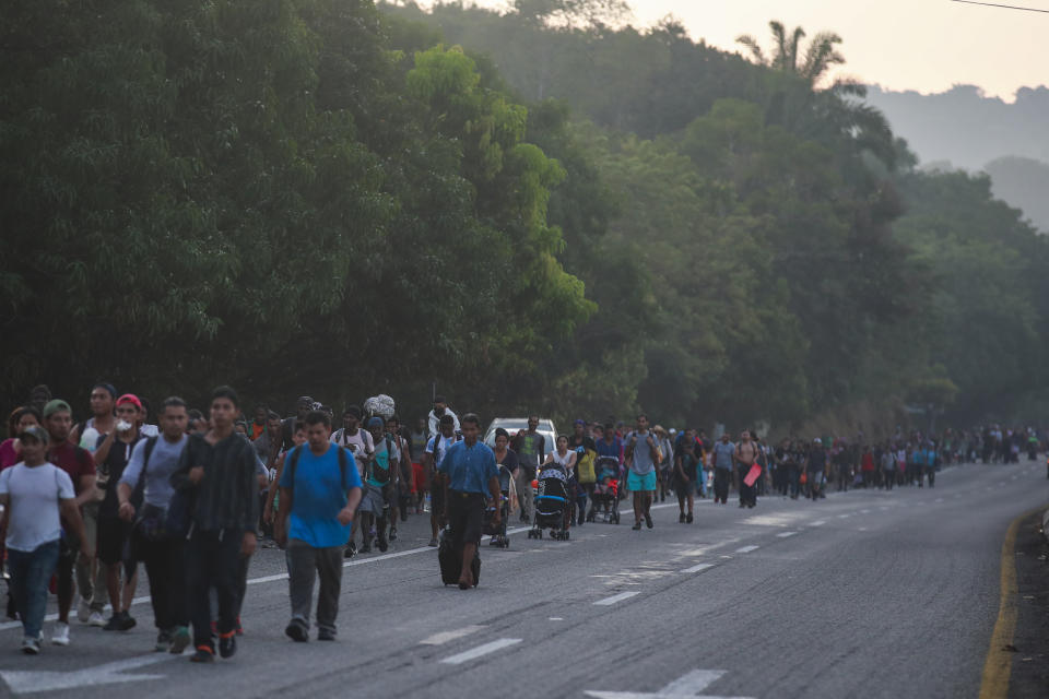 Migrants walk along the highway from Huehuetan to Huixtla in Chiapas state, Mexico, Friday, Nov. 19, 2021, on the second day of their journey from Tapachula, toward the northern states of Mexico and the U.S. border. (AP Photo)