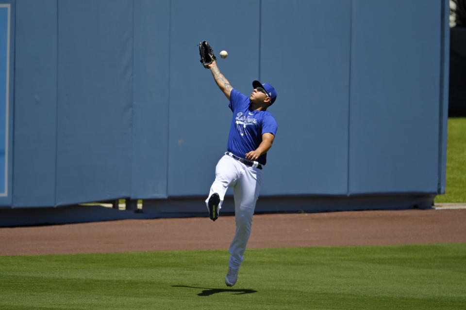 Los Angeles Dodgers relief pitcher Julio Urias misses a throw during the restart of spring training Friday, July 3, 2020, in Los Angeles. (AP Photo/Mark J. Terrill)a