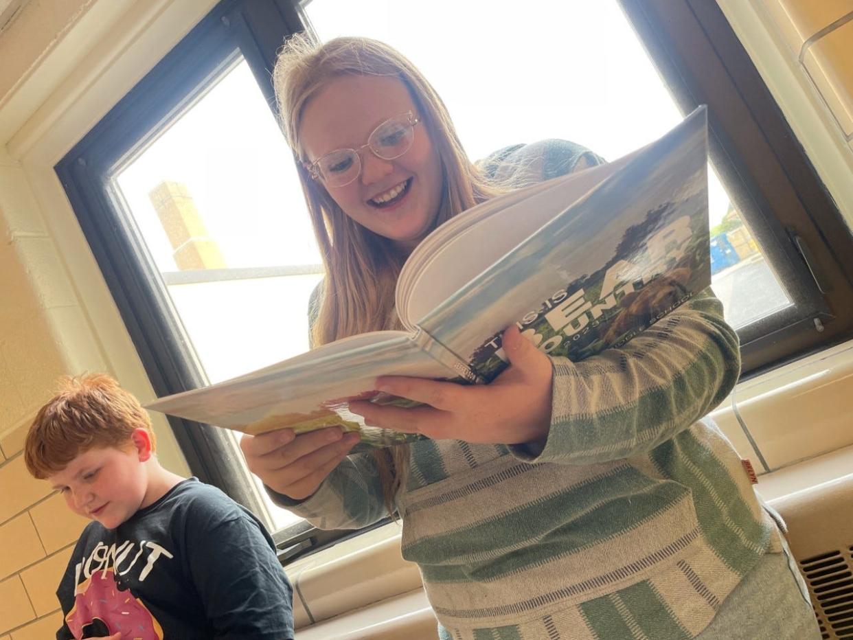 Jefferson Middle School yearbook staff members Patrick Jernigan and Novaleigh Stump see this year's yearbook for the first time.