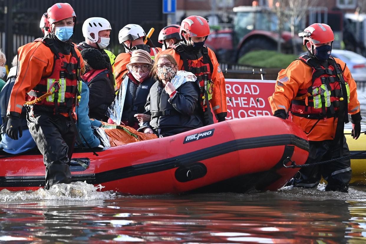 <p>Emergency services evacuate care home residents after they became stranded by flood water, in Northwich</p> (AFP via Getty Images)