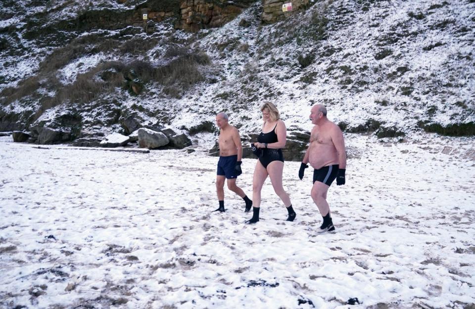 Early morning swimmers brave the cold at King Edward’s Bay, near Tynemouth on the North East coast of England (PA)