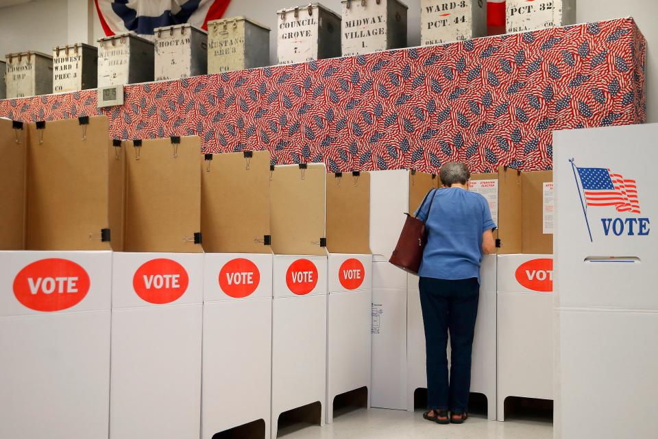 A women fills out her ballot during early voting at the Oklahoma County Election Board in Oklahoma City, Thursday, June 23, 2022. 