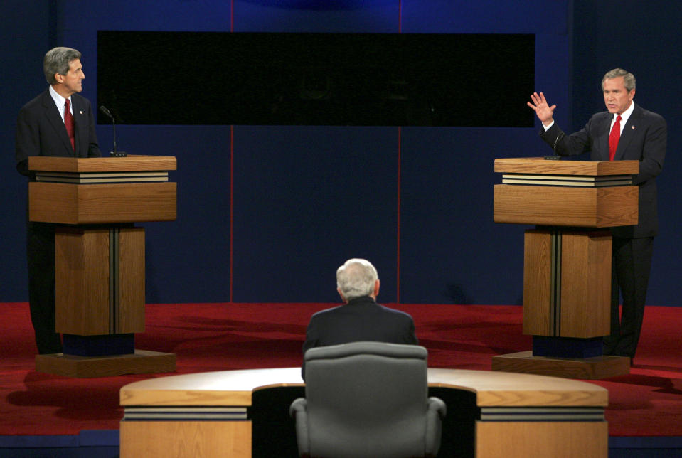 FILE - In this Oct. 13, 2004 file photo President Bush answers a question as his opponent, Democratic presidential candidate John Kerry, listens during the presidential debate in Tempe, Ariz. (AP Photo/Ron Edmonds, File)