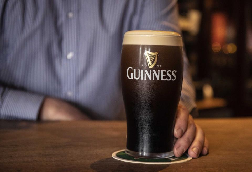 A barman at Mulligan’s in Poolbeg Street, Dublin, pours a pint of Guinness (Damien Eagers/PA) (PA Wire)