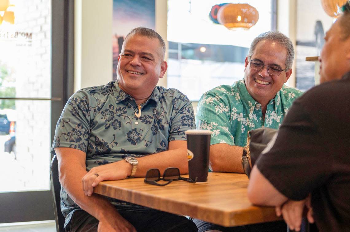 Founders of Mo’Bettahs Hawaiian Style Food, Kimo Mack, left and Kalani Mack, speak to customers during the restaurant’s “Friends and Ohana Day” on Thursday in Overland Park.