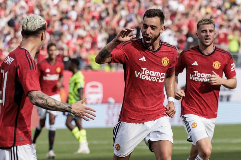 Manchester United's Bruno Fernandes (C) celebrates scoring a goal with teammate Antony (L), as Mason Mount (R) looks on during the first half of the 2023 Soccer Champions Tour club friendly match between Arsenal and Manchester United at Metlife Stadium in East Rutherford, New Jersey, in July 2023. File Photo by Justin Lane/EPA-EFE