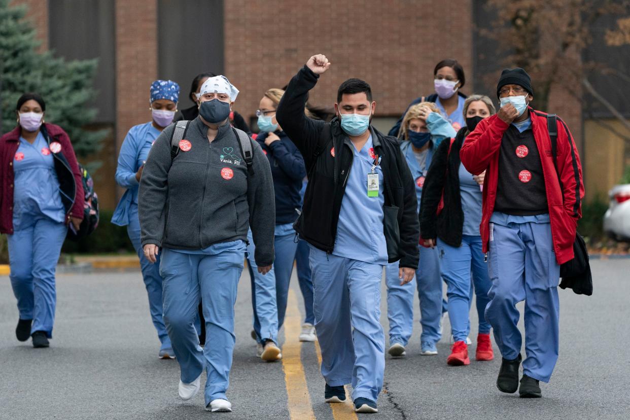 Nurses walk out of Montefiore New Rochelle Hospital to go on strike over safe staffing issues during the coronavirus pandemic, Tuesday, Dec. 1, 2020, in New Rochelle, N.Y.