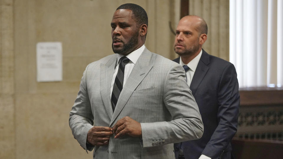 FILE - In this June 6, 2019, file photo, singer R. Kelly pleaded not guilty to 11 additional sex-related felonies during a court hearing before Judge Lawrence Flood at Leighton Criminal Court Building in Chicago. Kelly, who was arrested in Chicago on July 11, 2019 on a federal grand jury indictment listing 13 counts including sex crimes and obstruction of justice, was ordered held without bond on Tuesday, July 16. (E. Jason Wambsgans/Chicago Tribune via AP, Pool)