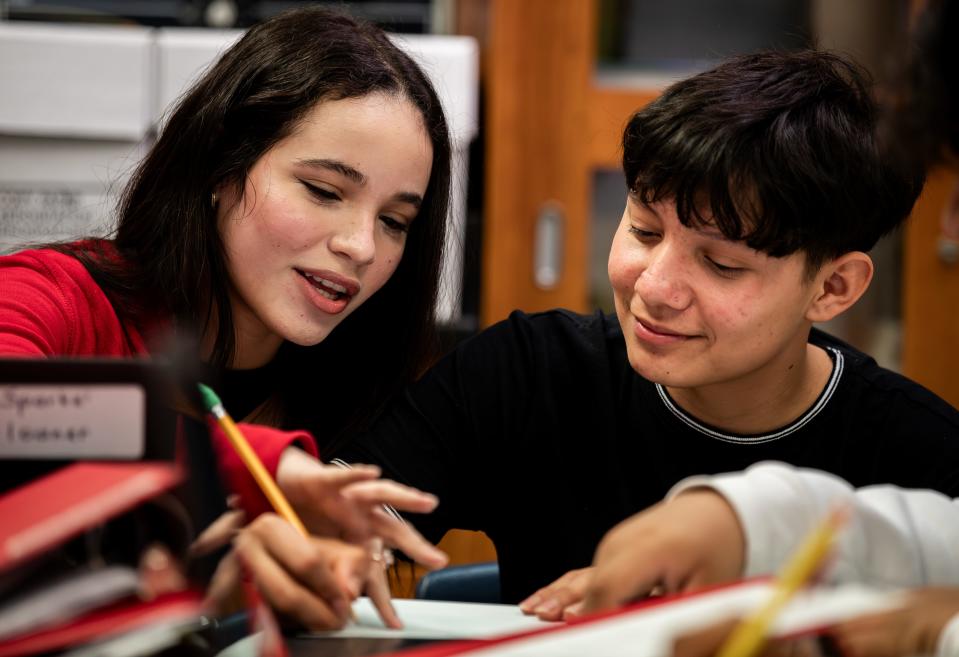 Seneca Junior Emily Camps, left, helped fellow junior Johan Lara Torres with his English during a recent biology class. Camps, who is originally from Cuba, says it took her a year to learn the English language with the help of the Duolingo app on her phone, and now she helps other students in her class by translating instructions and lessons in real time. March 8, 2024