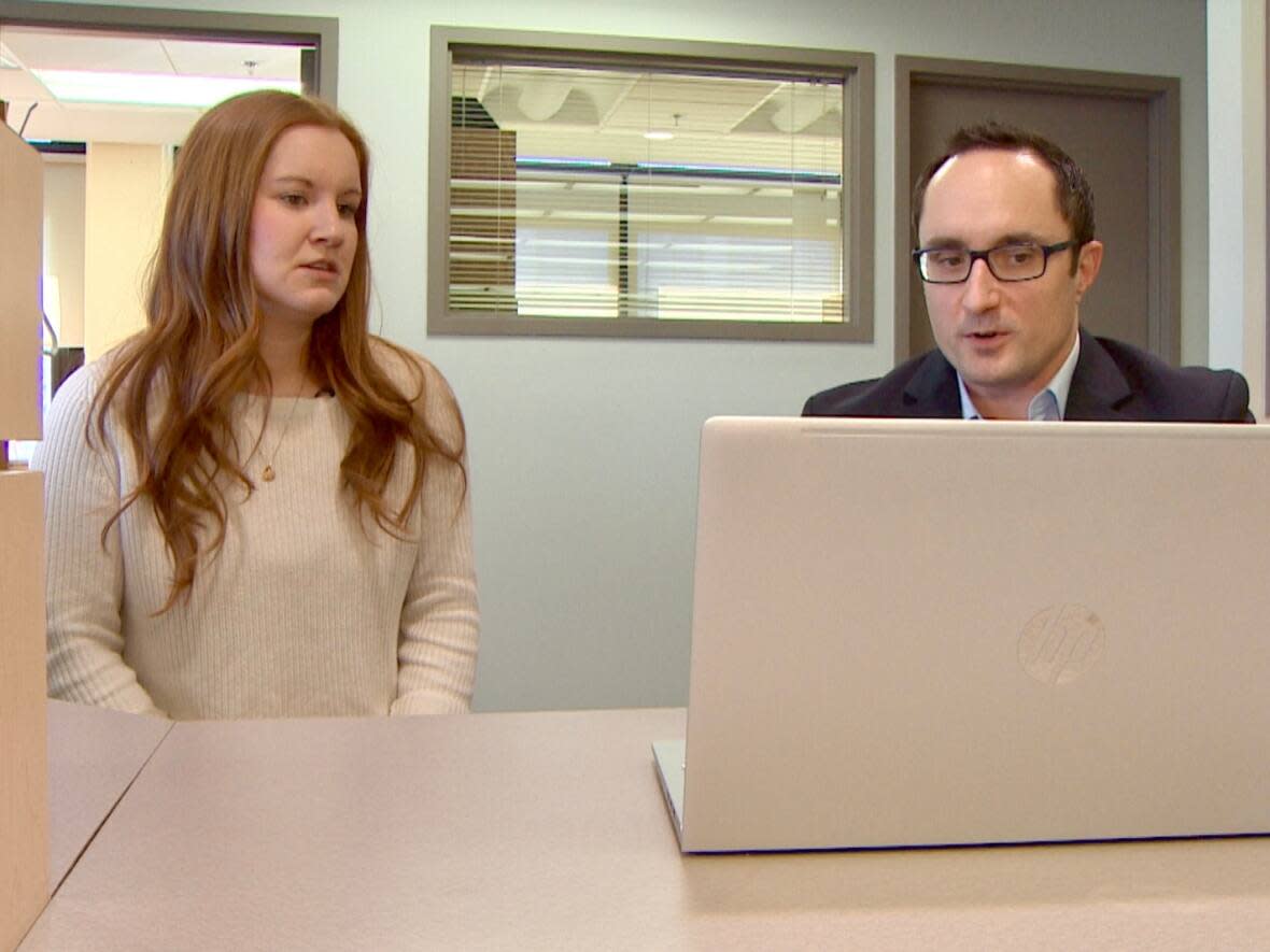 Jonathan Saumier, right, legal services support counsel at the Nova Scotia Barristers' Society, demonstrates how ChatGPT works. (CBC - image credit)