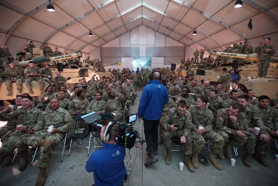 This image made from a video provided by Hyundai Motor America shows U.S. troops on U.S. military base in Zagan, Poland, watching Super Bowl 51 football game between the Atlanta Falcons and the New England Patriots in Houston during a party hosted by Hyundai. Hyundai aired an ad right after the Super Bowl that was recorded while the game was underway in Houston, Sunday, Feb. 5, 2017. The 90-second spot shows U.S. troops at the military base in Poland watching the game. A few service members are called into a room, where they are connected virtually to their family members — who are at the game. (Hyundai Motor America via AP)