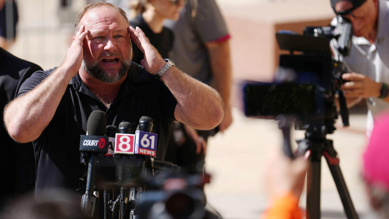 WATERBURY, CONNECTICUT - SEPTEMBER 21: InfoWars founder Alex Jones speaks to the media outside Waterbury Superior Court during his trial on September 21, 2022 in Waterbury, Connecticut. Jones is being sued by several victims' families for causing emotional and psychological harm after they lost their children in the Sandy Hook massacre. A Texas jury last month ordered Jones to pay $49.3 million to the parents of 6-year-old Jesse Lewis, one of 26 students and teachers killed in the shooting in Newtown, Connecticut. (Photo by Joe Buglewicz/Getty Images)