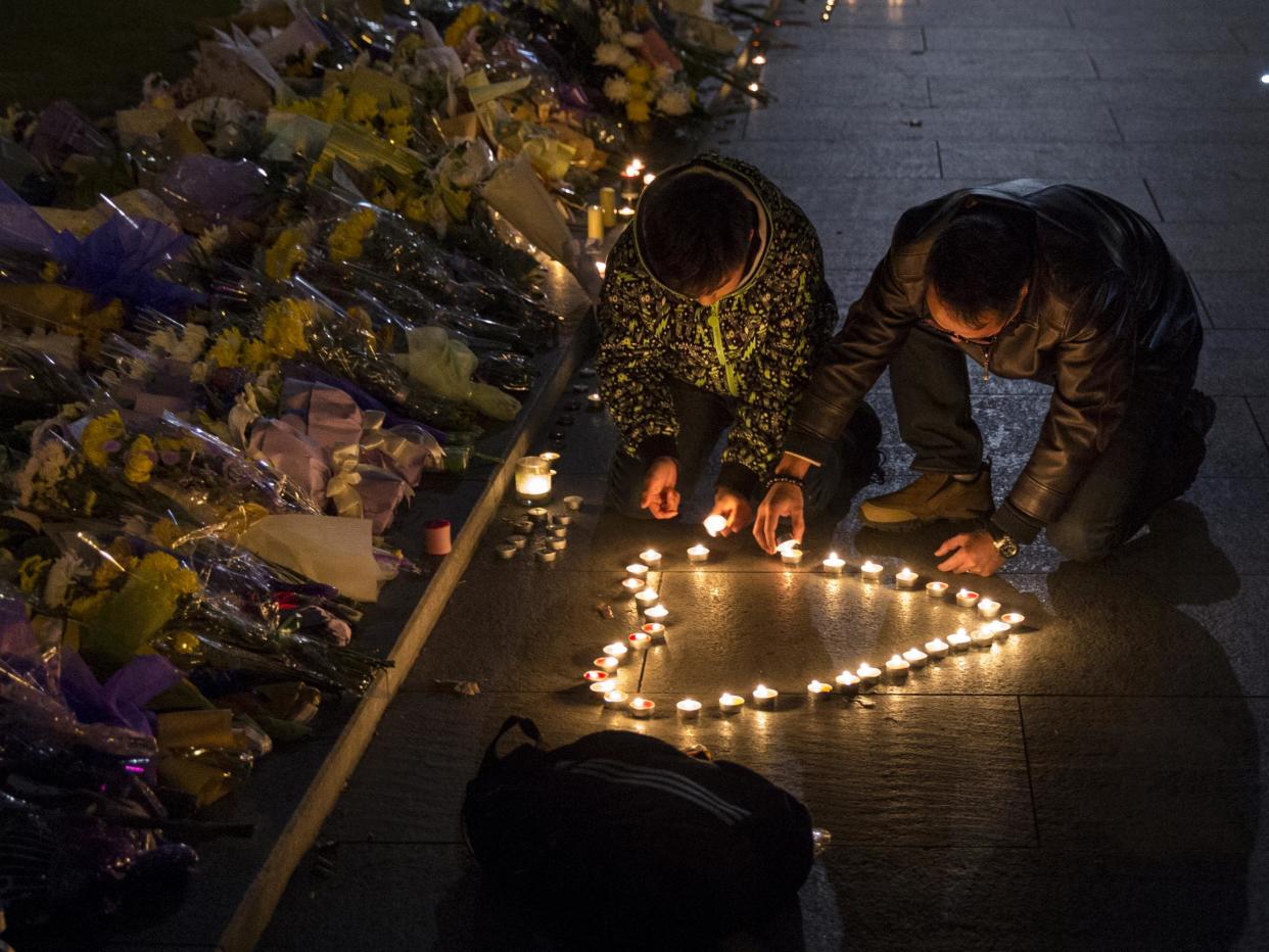 Mourners light candles in the shape of a heart at a makeshift memorial at the site of a stampede on 1 January, 2015: Getty