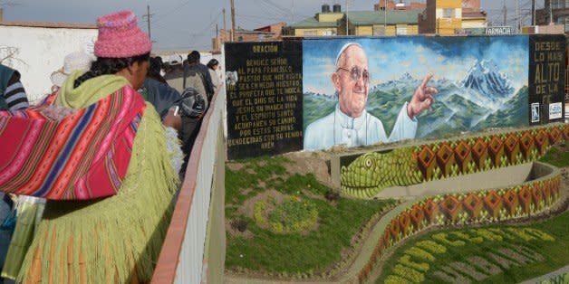 An indigenous woman is seen near a mural of Pope Francis in El Alto, Bolivia on July 3, 2015. Pope Francis will make a three-day visit to Bolivia next week. AFP PHOTO/Aizar Raldes        (Photo credit should read AIZAR RALDES/AFP/Getty Images) (Photo: )