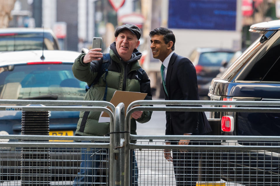 Sunak  LONDON, UNITED KINGDOM - MARCH 20, 2022: A member of the public takes a selfie with Chancellor of the Exchequer Rishi Sunak as he arrives at the BBC Broadcasting House in central London to appear on the Sunday Morning show hosted by Sophie Raworth on March 20, 2022 in London, England. Chancellor Rishi Sunak is set to deliver the Spring Statement at the House of Commons on Wednesday 23 March amid surging cost of living and energy crisis. (Photo credit should read Wiktor Szymanowicz/Future Publishing via Getty Images)