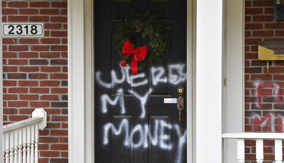 Graffiti reading, "Where's my money" is seen on a door of the home of Senate Majority Leader Mitch McConnell, R-Ky., in Louisville, Ky., on Saturday, Jan. 2, 2021. As of Saturday morning, messages like “where’s my money” and other expletives were written with spray paint across the front door and bricks of the Kentucky Republican’s Highlands residence. (AP Photo/Timothy D. Easley)