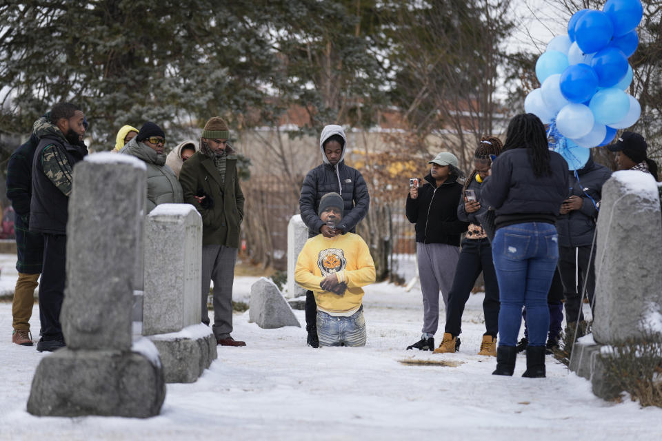 Timere Jones, center, carries a life-sized picture of his brother, Jameek Lowery, as he and other family and friends visit his grave in Garfield, N.J., Thursday, Jan. 18, 2024. Lowery’s case underscores how hard it can be for families to hold officers accountable, as well as how difficult it can be to pry loose information about deadly encounters. (AP Photo/Seth Wenig)