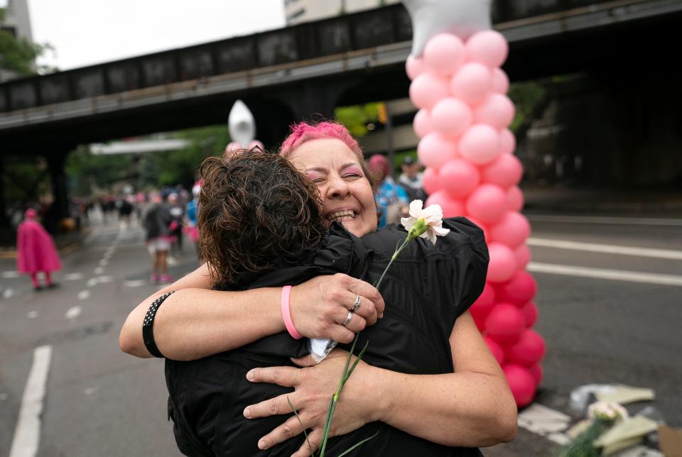 Breast cancer survivor Amy Callahan receives a hug from friend Pam Riggs at the end of the 2023 Komen Columbus Race for the Cure. Callahan has been cancer free for 1½ years.