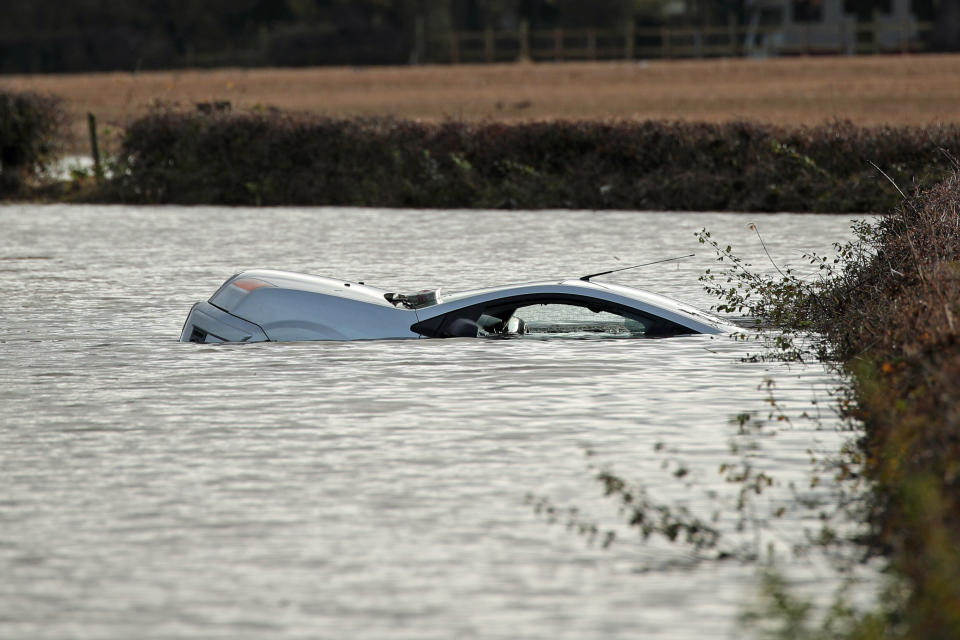 A car floats in floodwater near Fishlake in Doncaster. The Prime Minister is set to chair a meeting of the Government's emergency committee after severe flooding in parts of the country, where rain is finally expectedd to ease this afternoon.