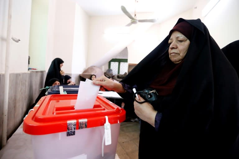 An Iranian woman casts her ballot in presidential elections at a polling station in southern Tehran on May 19, 2017