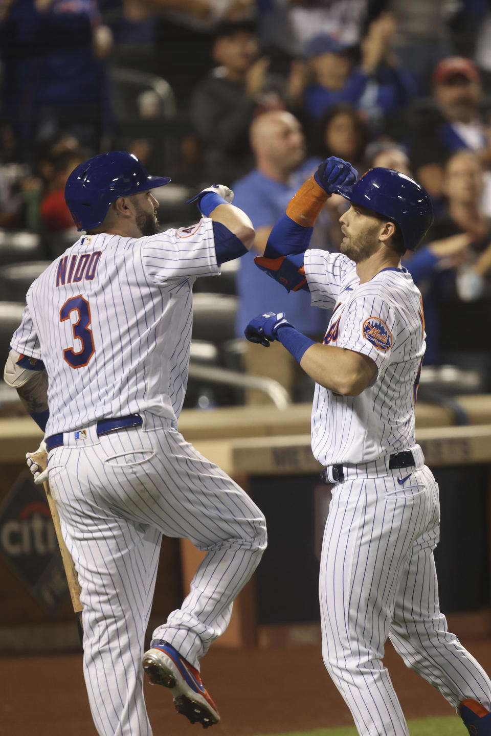 New York Mets' Jeff McNeil, right, celebrates with teammate Tomas Nido after hitting a home run during the seventh inning of a baseball game against the Philadelphia Phillies, Sunday, Sept. 19, 2021, in New York. (AP Photo/Jason DeCrow)