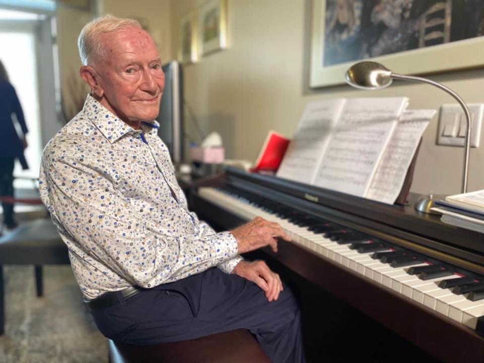 Harry Mitchell, 100, stays young at heart by setting and meeting new challenges for himself. He learned to play the piano at 89. (Grant Linton/ CBC Toronto - image credit)