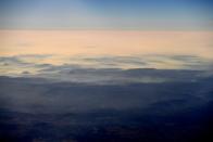 Smoke from bushfires blanket mountain ranges as seen during a commercial flight over northern New South Wales