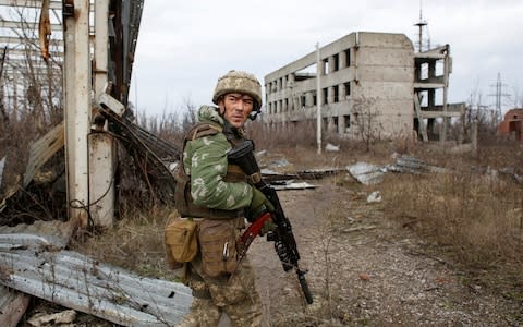 A Ukrainian serviceman on patrol near the frontline in eastern Ukraine, 2017 - Credit: Anatolii Stepanov for the Telegraph