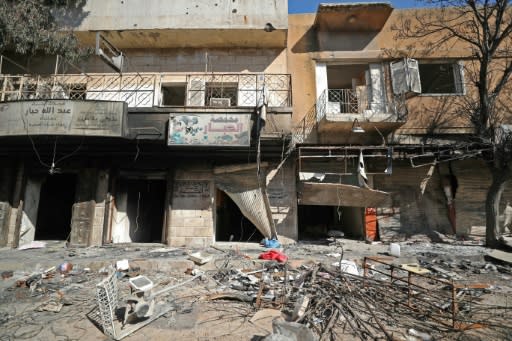 Damaged shops and rubble-strewn streets in the Idlib town of Saraqeb