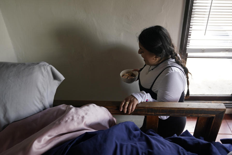 University of California, Berkeley student Jennifer Lopez, makes her way down a tiny set of stairs from her bedroom loft of the apartment she shares with three others in Berkeley, Calif., Tuesday, March 29, 2022. Millions of college students in the U.S. are trying to find an affordable place to live as rents surge nationally, affecting seniors, young families and students alike. (AP Photo/Eric Risberg)