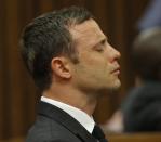 Olympic and Paralympic track star Oscar Pistorius reacts as he listens to Judge Thokozile Masipa's judgement at the North Gauteng High Court in Pretoria, September 11, 2014. A South African judge cleared Oscar Pistorius of all murder charges on Thursday, saying prosecutors had failed to prove the Olympic and Paralympic track star intended to kill his girlfriend or an imagined intruder on Valentine's Day last year. REUTERS/Kim Ludbrook/Pool (SOUTH AFRICA - Tags: SPORT ATHLETICS ENTERTAINMENT CRIME LAW SOCIETY)