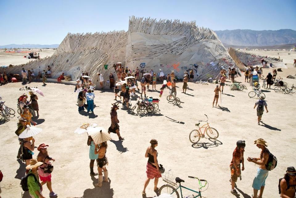 n this photo taken Wednesday, Sept. 1, 2010, Burners congregate around "The Temple of Flux," a spiritual place for many at Burning Man 2010 in Black Rock City, Nv. It's never been so hard to be a hippie. A quarter century after the free spirits moved their party from San Francisco's Baker Beach to a dried up ancient lake bed 110 miles north of Reno, the Burning Man counterculture festival is faced with turning large numbers of its longtime participants away. With its drum circles and decorated art cars, guerilla theatrics and colorful theme camps, the annual pilgrimage to the playa in the name of both everything and nothing has become just too darn popular for its own good. (AP Photo/The Reno Gazette-Journal, Vince Alonzo)