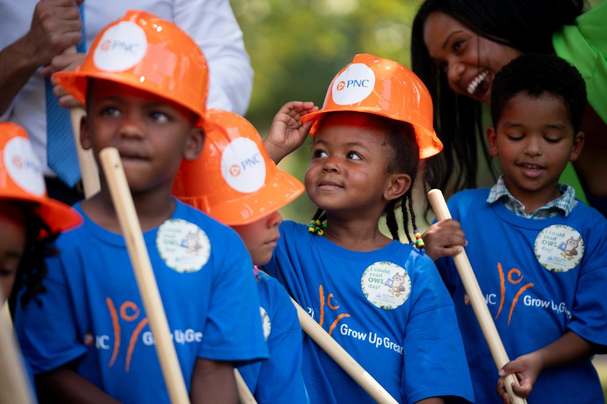 Napier Elementary School pre-K students, from left, Khalyn Salters, 3, Kyle Johnson, 4, Kyzala Bauman, 4, and Salmon Ali, 4, turn the ceremonial dirt for the cameras during the groundbreaking ceremony for the Storybook Trail outdoor learning space at Napier Elementary School in Nashville, Tenn., Thursday, Aug. 29, 2024.