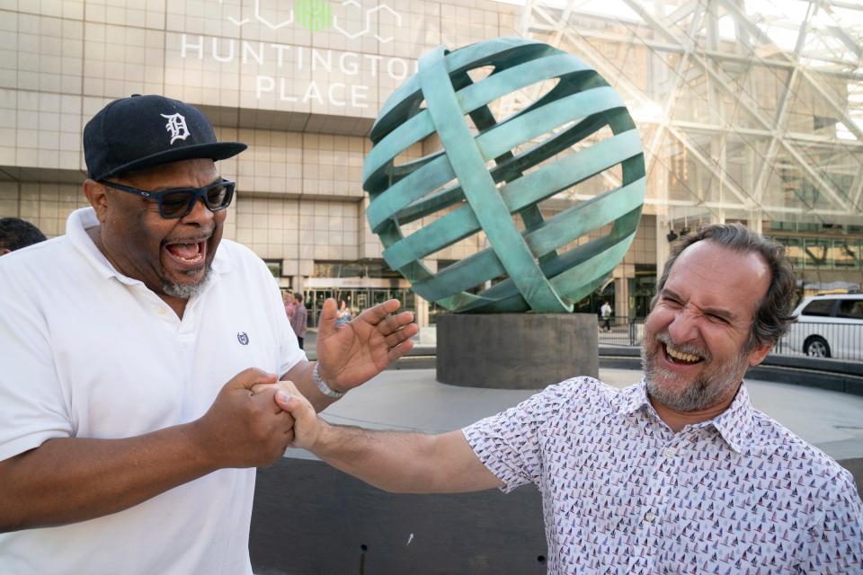 Fellow artist and friend Saffell Gardner, left, congratulates Scott Hocking after the unveiling of Hocking's sculpture "Floating Citadel" on Wednesday Aug. 17, 2022 in front of Huntington Place.