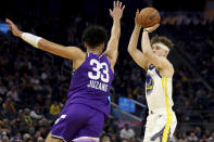 Golden State Warriors guard Brandin Podziemski (2) looks to shoot against Utah Jazz guard Johnny Juzang (33) during the first half of an NBA basketball game in San Francisco, Sunday, April 14, 2024. (AP Photo/Jed Jacobsohn)