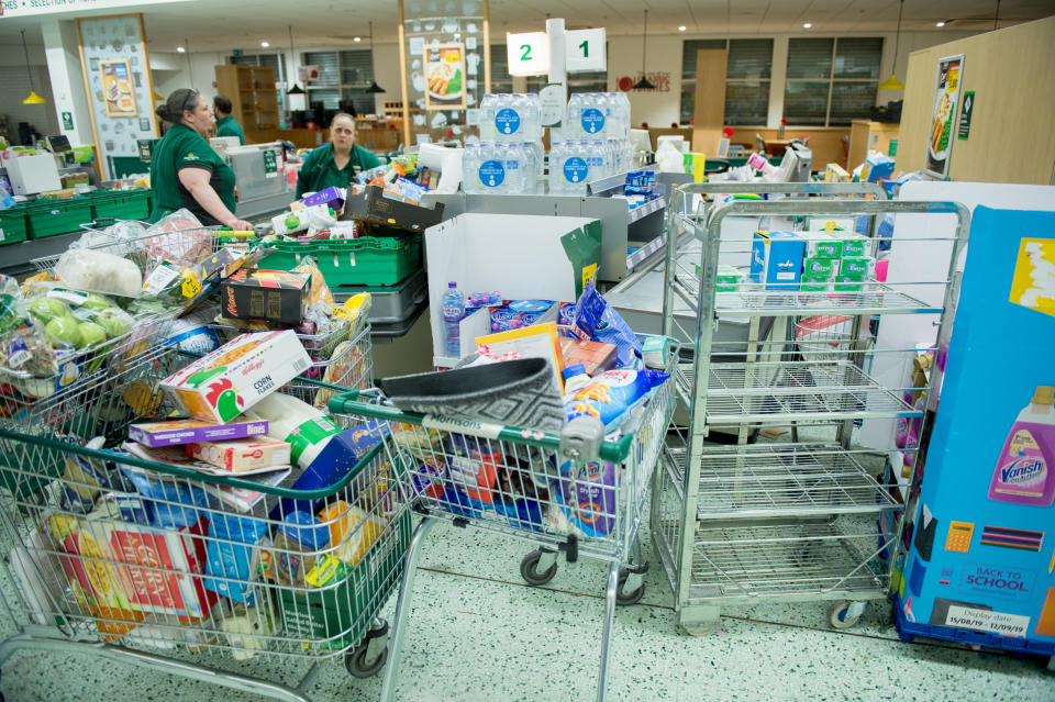 LONDON, ENGLAND - MARCH 14:  Workers collect items to restock the empty shelves in a London Morrisons store as panic-buying over coronavirus continues on March 14, 2020 in London England. Members of the British Retail Consortium have sent a letter to the public urging them to work together as retailers have been sold out of essentials from over buying during the ongoing threat of the COVID-19 outbreak. (Photo by Ollie Millington/Getty Images)