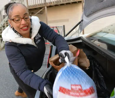 The United Way of Tri-County provided Thanksgiving meals to about 800 families last year at the Pearl Street Cupboard and Cafe in Framingham, Nov. 23, 2021. Here, warehouse supervisor Clara Rodriguez loads a trunk with food.