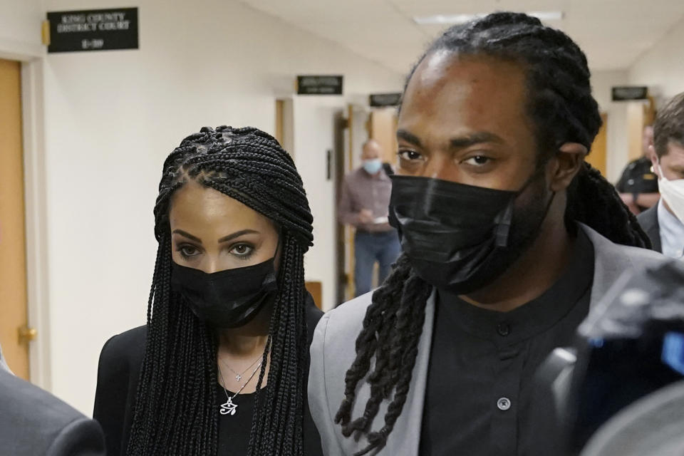 FILE - Richard Sherman, right, walks with his wife following a King County District Court hearing in Seattle, in this Friday, July 16, 2021, filer photo. The Tampa Bay Buccaneers have signed Richard Sherman, a three-time All-Pro cornerback and Super Bowl champion who has been dealing with legal issues in the offseason. Sherman got a one-year deal Wednesday, Sept. 29, 2021, and said Tom Brady helped recruit him to the defending Super Bowl champions, who have been hit hard by injuries to their secondary. (AP Photo/Ted S. Warren, File)