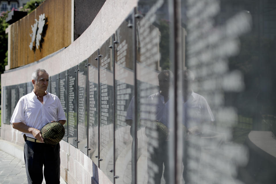 Diego Carlos Arreseigor poses with a British soldier's helmet that he found on the battlefield in 1982 at the monument that honors Argentine soldiers killed during the Falklands war in Buenos Aires, Argentina Wednesday, March 7, 2018. Arreseigor is planning to return the blood-stained helmet of fallen British soldier Alexander Shaw, who was killed in the battle of Mount Longdon at the age of 25, to Shaw's sister in April or May. (Diego Carlos Arreseigor via AP)