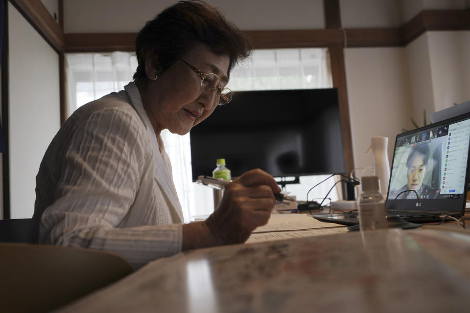 Michiko Kodama, assistant secretary-general of the Japan Confederation of A and H Bomb Sufferers' Organizations, takes a question from an audience after she narrated her experience on a livestream of "Kataribe" or story-telling session Sunday, July 12, 2020, in Tokyo. “For me, the war is not over yet,” said Michiko Kodama, 82, who survived the bombing but has lost most of her relatives from cancer, including one of her two daughters. Years after the atomic bombing, a receptionist at a clinic near Tokyo noted Kodama's “hibakusha” medical certificate in a loud voice, and a patient sitting next to her in a waiting room moved away from her. The fear of death, prejudice and discrimination at work and in marriage continues, and nuclear weapons still exist. (AP Photo/Eugene Hoshiko)