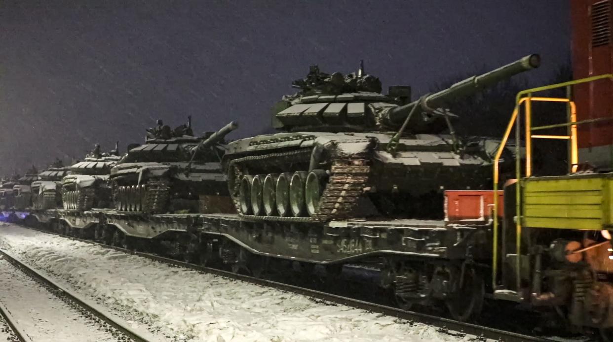 In this photo taken from video provided by the Russian Defense Ministry Press Service on Friday, Feb. 18, 2022, Russian army tanks are loaded onto railway platforms to move back to their permanent base after drills in Russia. The Russian military said that it was pulling some troops back to their permanent bases after drills in regions near Ukraine, but the U.S. and its allies challenged that and charged that Moscow was actually beefing up troops near Ukraine.