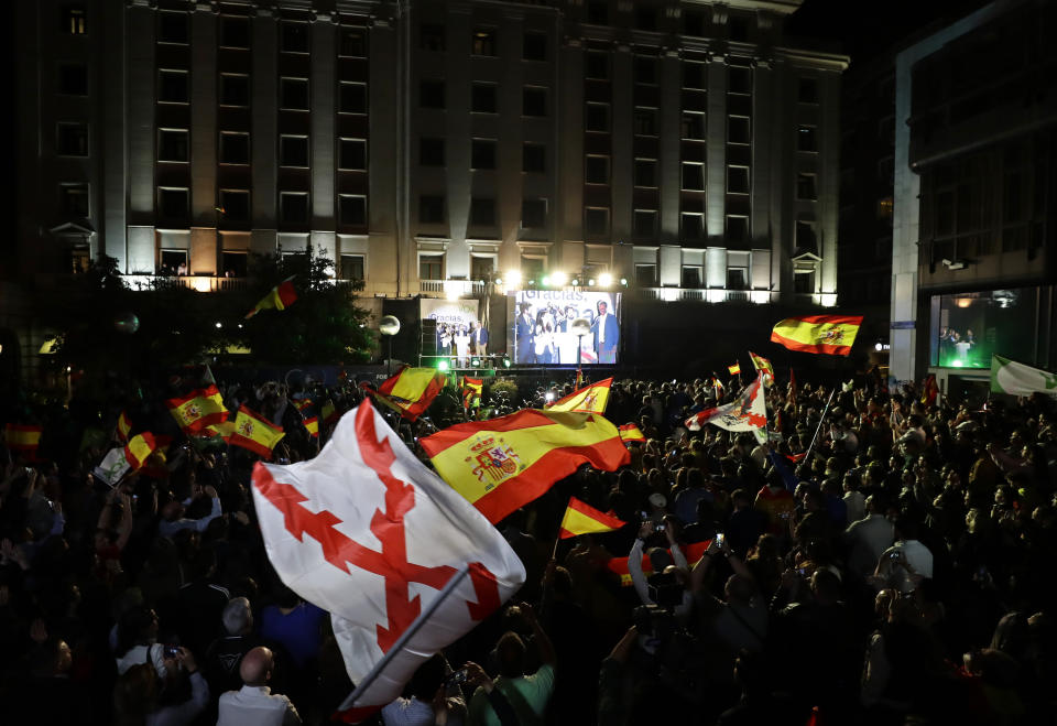 Supporters of far right party Vox cheer as party leader Santiago Abascal addresses them outside the party headquarters following the general election in Madrid, Sunday, April 28, 2019. A divided Spain voted Sunday in its third general election in four years, with all eyes on whether a far-right party will enter Parliament for the first time in decades and potentially help unseat the Socialist government. (AP Photo/Manu Fernandez)