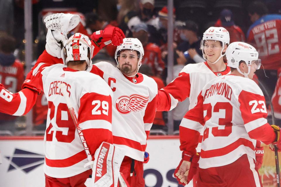 Detroit Red Wings center Dylan Larkin (71) celebrates with Red Wings goaltender Thomas Greiss (29) after scoring the game winning goal in overtime against the Washington Capitals at Capital One Arena on Wednesday, Oct. 27, 2021.